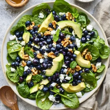 Fresh spinach blueberry salad served in a bowl with vibrant colors