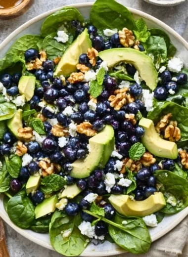 Fresh spinach blueberry salad served in a bowl with vibrant colors