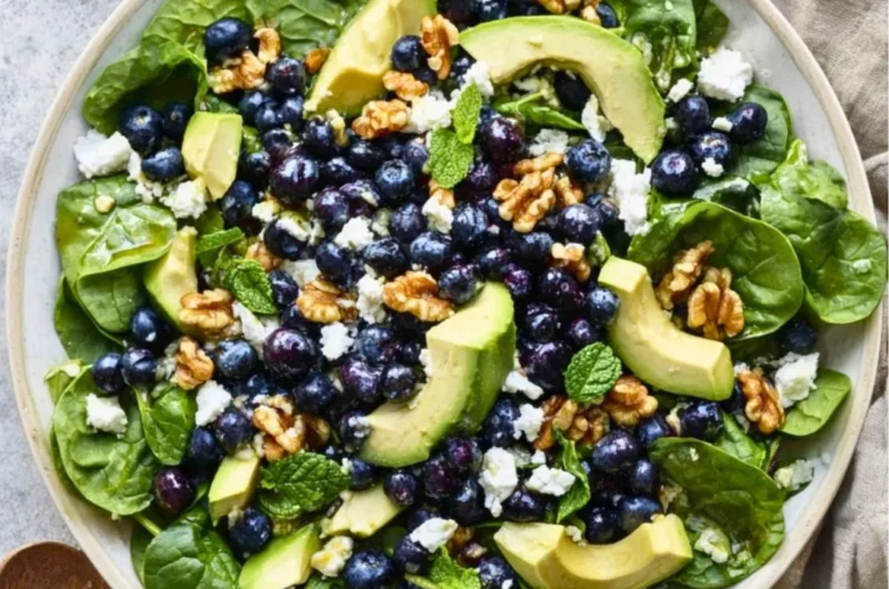 Fresh spinach blueberry salad served in a bowl with vibrant colors