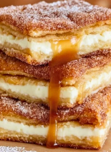 Delicious churro cheesecake topped with cinnamon sugar and drizzled with caramel.