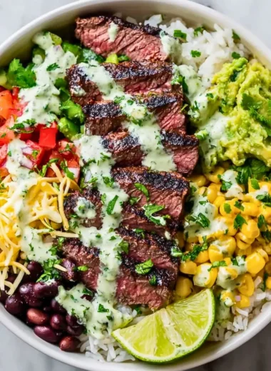 Cilantro lime steak bowl garnished with fresh cilantro and lime wedges