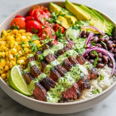 Cilantro lime steak bowls garnished with fresh vegetables and herbs
