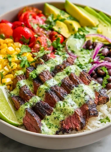 Cilantro lime steak bowls garnished with fresh vegetables and herbs