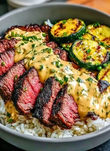Delicious Grilled Steak Bowl with sauce and grilled zucchini served in a bowl.