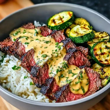 Delicious Grilled Steak Bowl with sauce and grilled zucchini