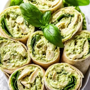 Delicious pesto chicken salad served with fresh vegetables on a plate