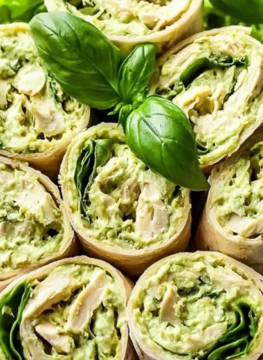 Delicious pesto chicken salad served with fresh vegetables on a plate