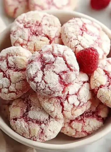 Plate of homemade raspberry sugar cookies with fresh raspberries