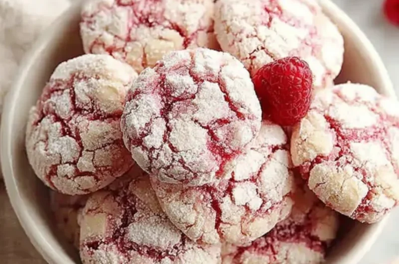 Plate of homemade raspberry sugar cookies with fresh raspberries