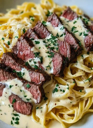 Savory steak gorgonzola alfredo with creamy parmesan sauce served on a plate