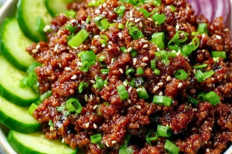 Delicious Spicy Keto Korean Beef served with cucumber salad on a plate.