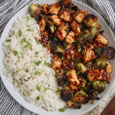 Air fried chicken breast served with roasted Brussels sprouts on a plate.