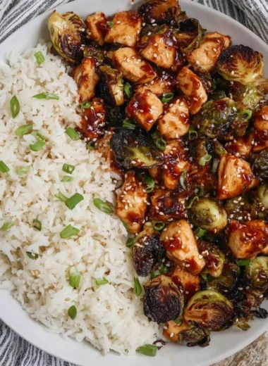 Air fried chicken breast served with roasted Brussels sprouts on a plate.