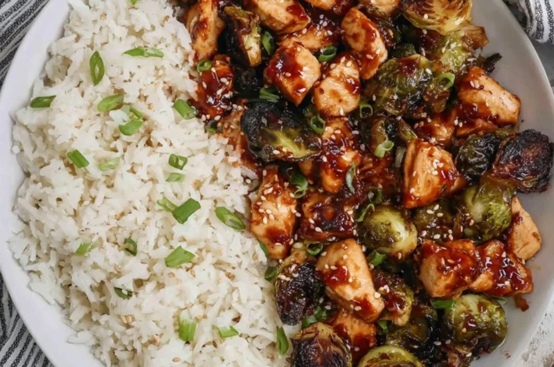 Air fried chicken breast served with roasted Brussels sprouts on a plate.