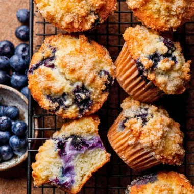 Freshly baked bakery style blueberry muffins with blueberries on top