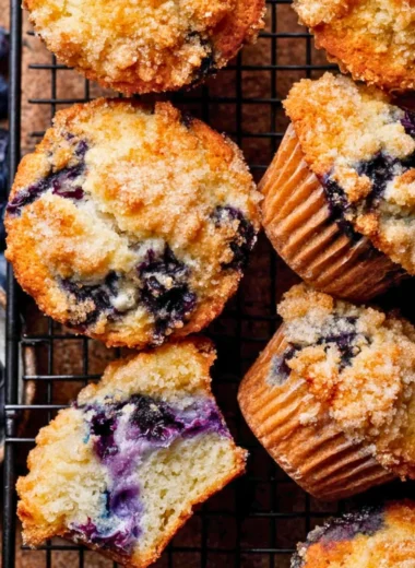 Freshly baked bakery style blueberry muffins with blueberries on top