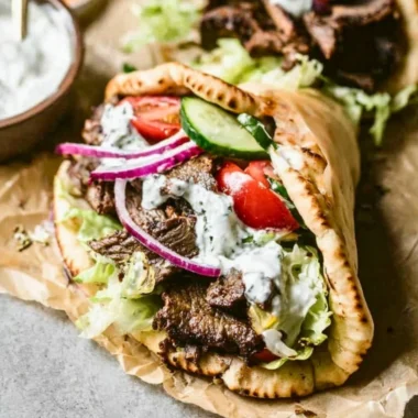 Delicious homemade beef gyros served with fresh toppings and pita bread