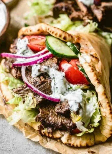 Delicious homemade beef gyros served with fresh toppings and pita bread