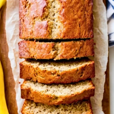 Delicious slice of homemade banana bread on a wooden table