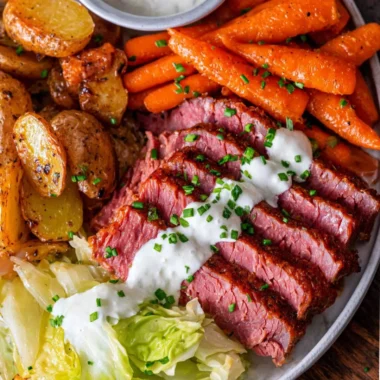 Delicious corned beef and cabbage served on a plate with carrots