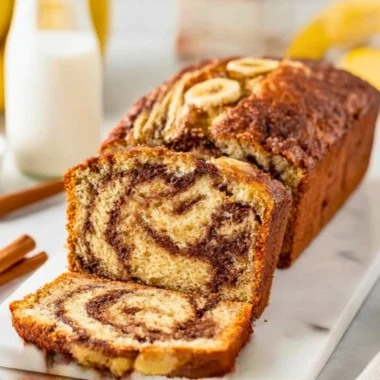 A slice of cinnamon swirl banana bread showcasing its moist texture and swirl pattern.