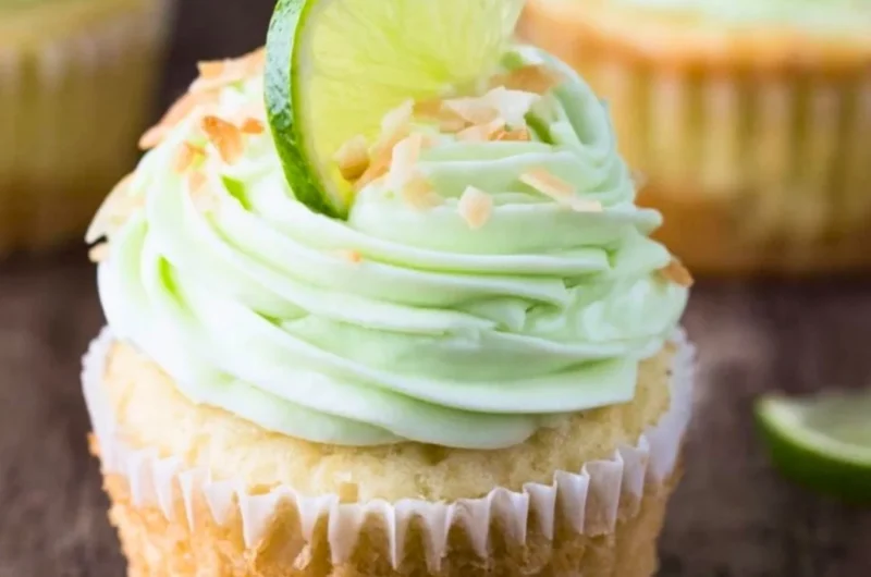 Delicious coconut cupcakes with lime buttercream frosting on a decorative plate.