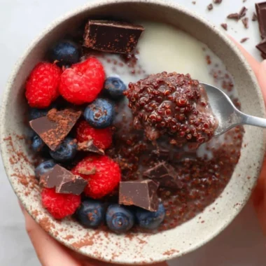 Dark Chocolate Quinoa Breakfast Bowl topped with fruits and nuts.