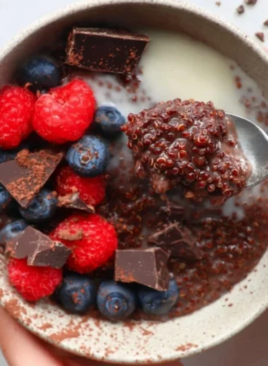 Dark Chocolate Quinoa Breakfast Bowl topped with fruits and nuts.