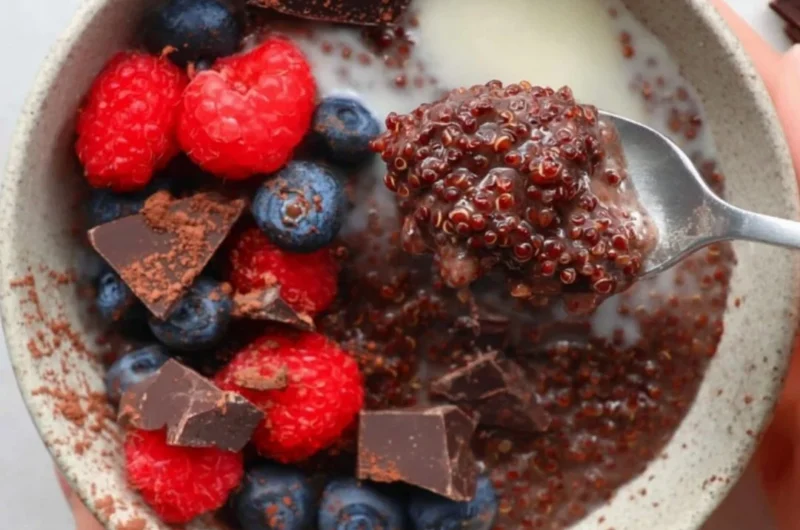 Dark Chocolate Quinoa Breakfast Bowl topped with fruits and nuts.