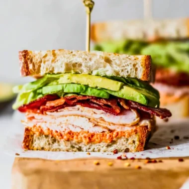 Easy turkey club sandwich with layers of turkey, bacon, lettuce, and tomato
