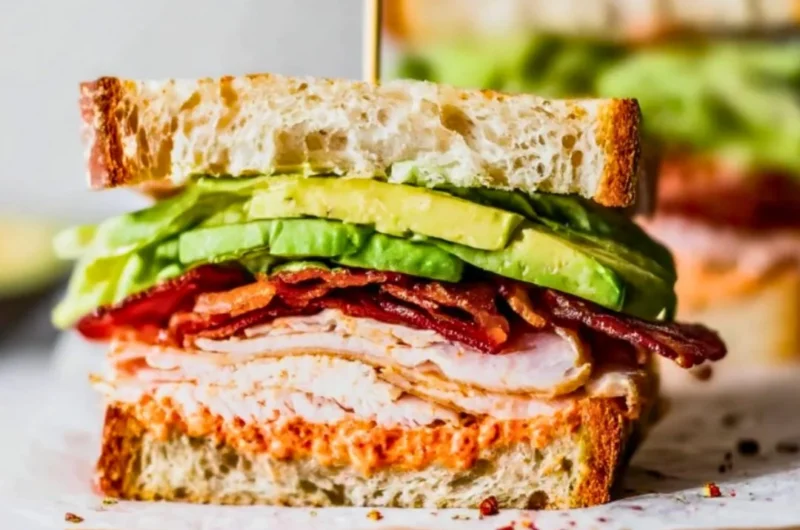 Easy turkey club sandwich with layers of turkey, bacon, lettuce, and tomato
