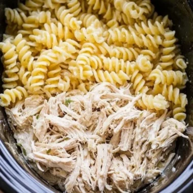 Delicious Garlic Parmesan Chicken Pasta served with herbs and cheese