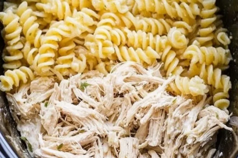 Delicious Garlic Parmesan Chicken Pasta served with herbs and cheese