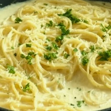 Creamy Garlic Parmesan Sauce drizzled over pasta