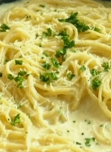 Creamy Garlic Parmesan Sauce drizzled over pasta