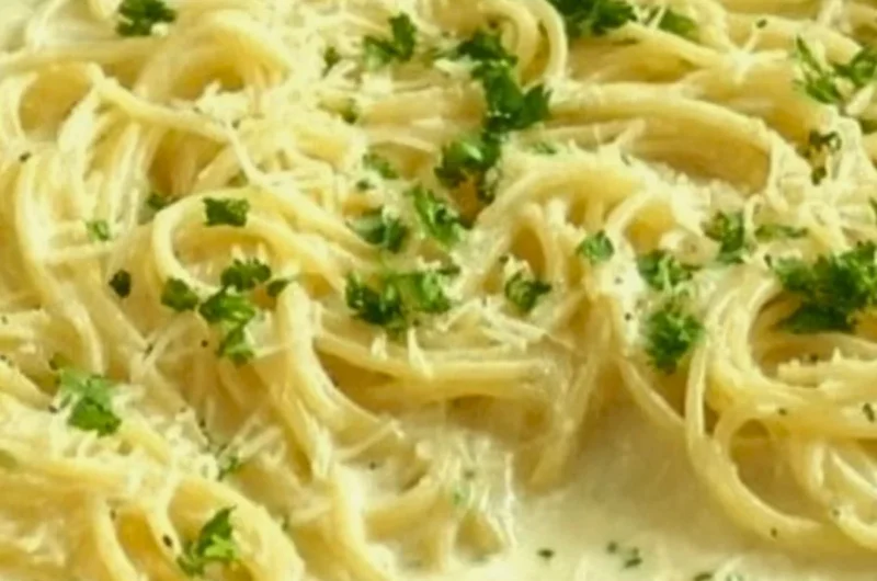 Creamy Garlic Parmesan Sauce drizzled over pasta
