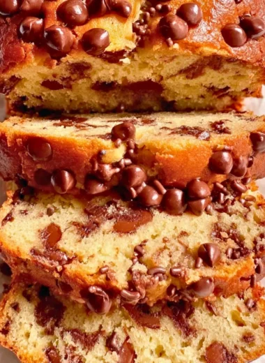 Slice of Greek Yogurt Cake topped with fresh berries on a white plate