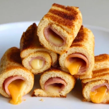 Cheesy grilled cheese roll-ups with melted cheese on crispy bread