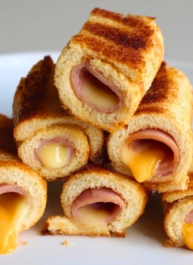 Cheesy grilled cheese roll-ups with melted cheese on crispy bread