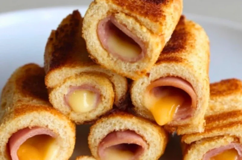 Cheesy grilled cheese roll-ups with melted cheese on crispy bread