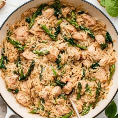 High Protein Chicken Orzo dish served in a bowl with herbs.