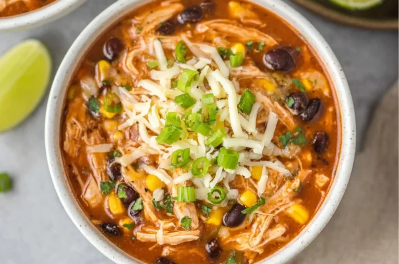 Bowl of high protein chicken taco soup garnished with cilantro and avocado