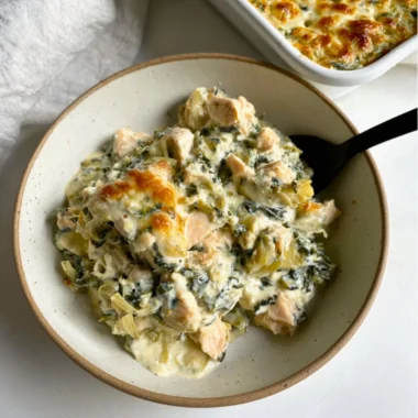 High-protein spinach artichoke chicken casserole served in a baking dish