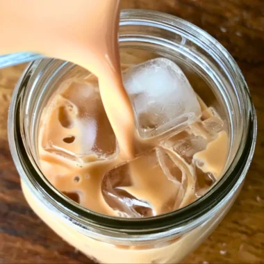 Iced English Tea Latte served in a glass with ice and tea leaves