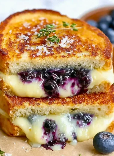 Juicy blueberry grilled cheese sandwich with melted cheese and blueberries