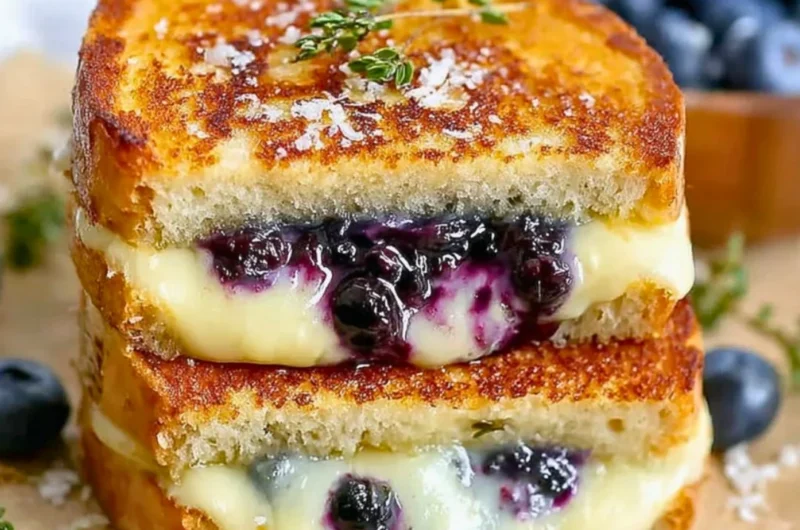 Juicy blueberry grilled cheese sandwich with melted cheese and blueberries