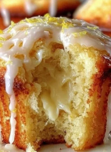 Freshly baked lemon cream cheese muffins on a plate