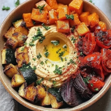 Delicious roasted veggie and hummus bowl with fresh ingredients
