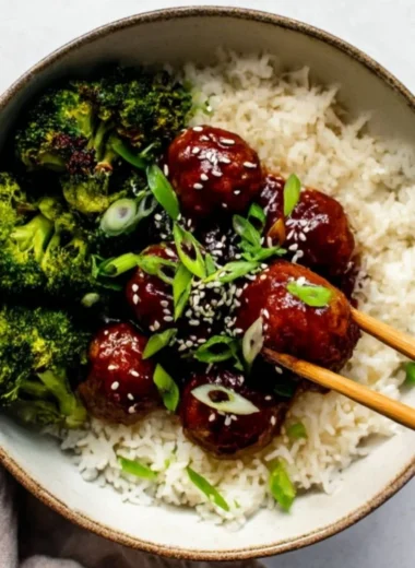 Sticky Mongolian Beef Meatballs served on a plate with garnish.
