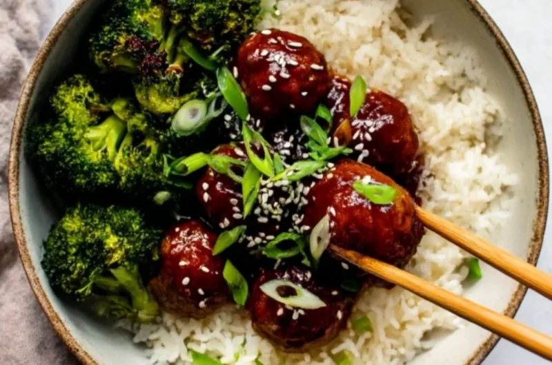 Sticky Mongolian Beef Meatballs served on a plate with garnish.